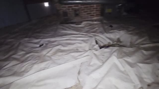 Crawl-space ground covering and brick support photographed during Fairytale site work